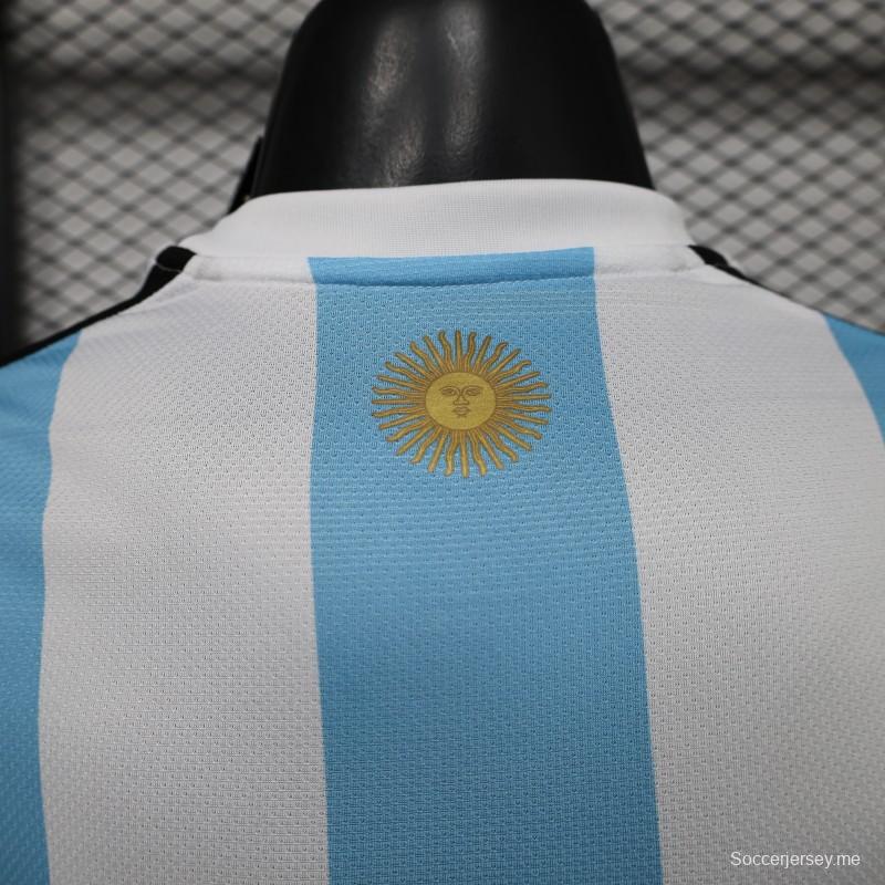 قميص المنتخب الأرجنتيني للمباريات على أرضه، إصدار اللاعب 2027، باللونين الأبيض والأزرق الفاتح مع شارة بطل كأس العالم FIFA