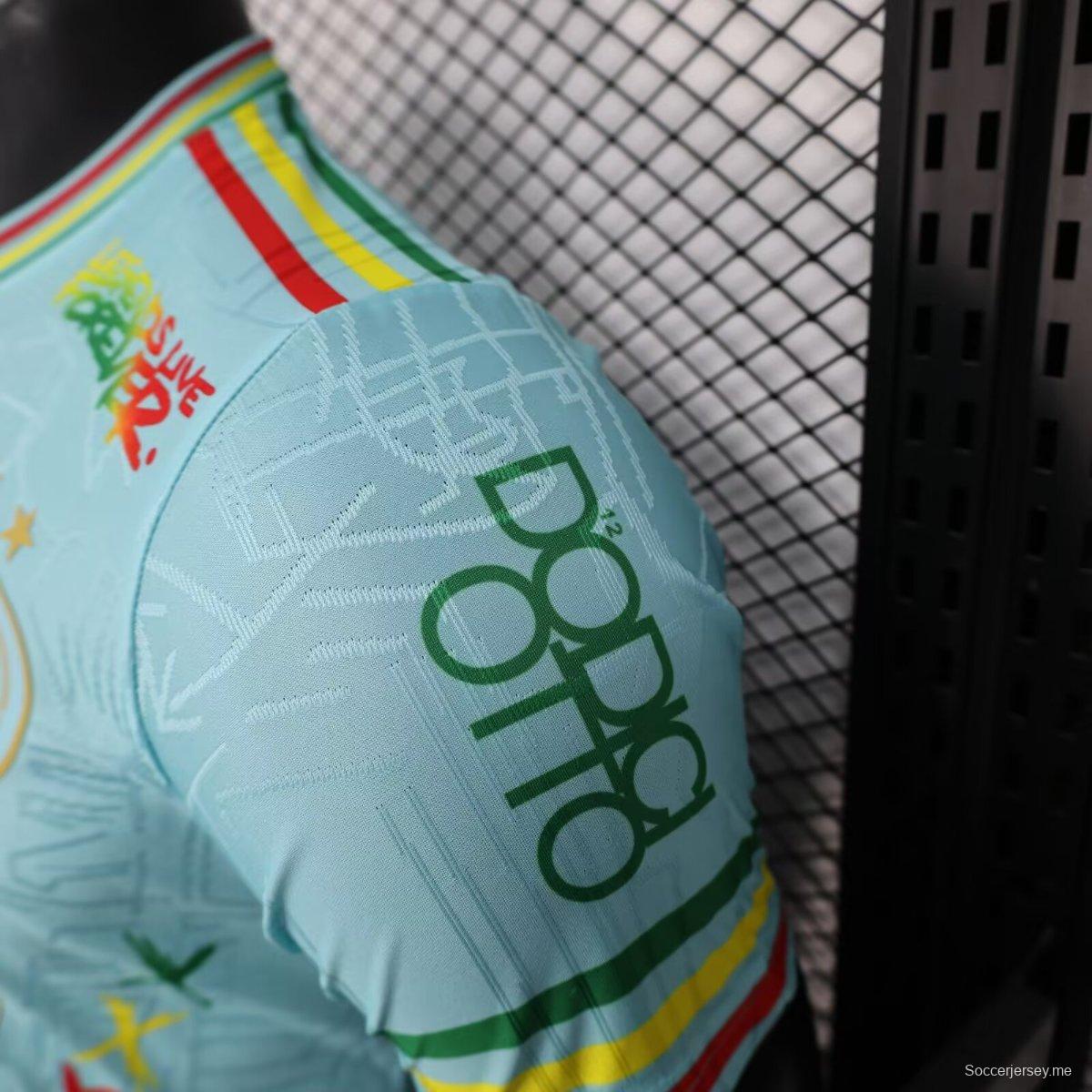 إصدار اللاعب 25/26 قميص أياكس 25/26 أزرق سماوي أزرق داكن مع قميص بوب مارلي التذكاري